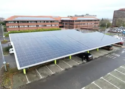 Solar carport featuring solar power panels, providing shade and renewable energy in a commercial parking lot at Civic Centre Gateshead England solar canopies